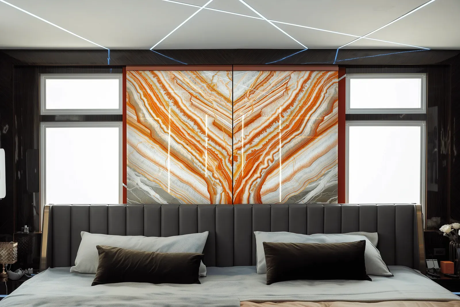 Bedroom headboard wall in orange stone, two bookmatched slabs mirroring each other